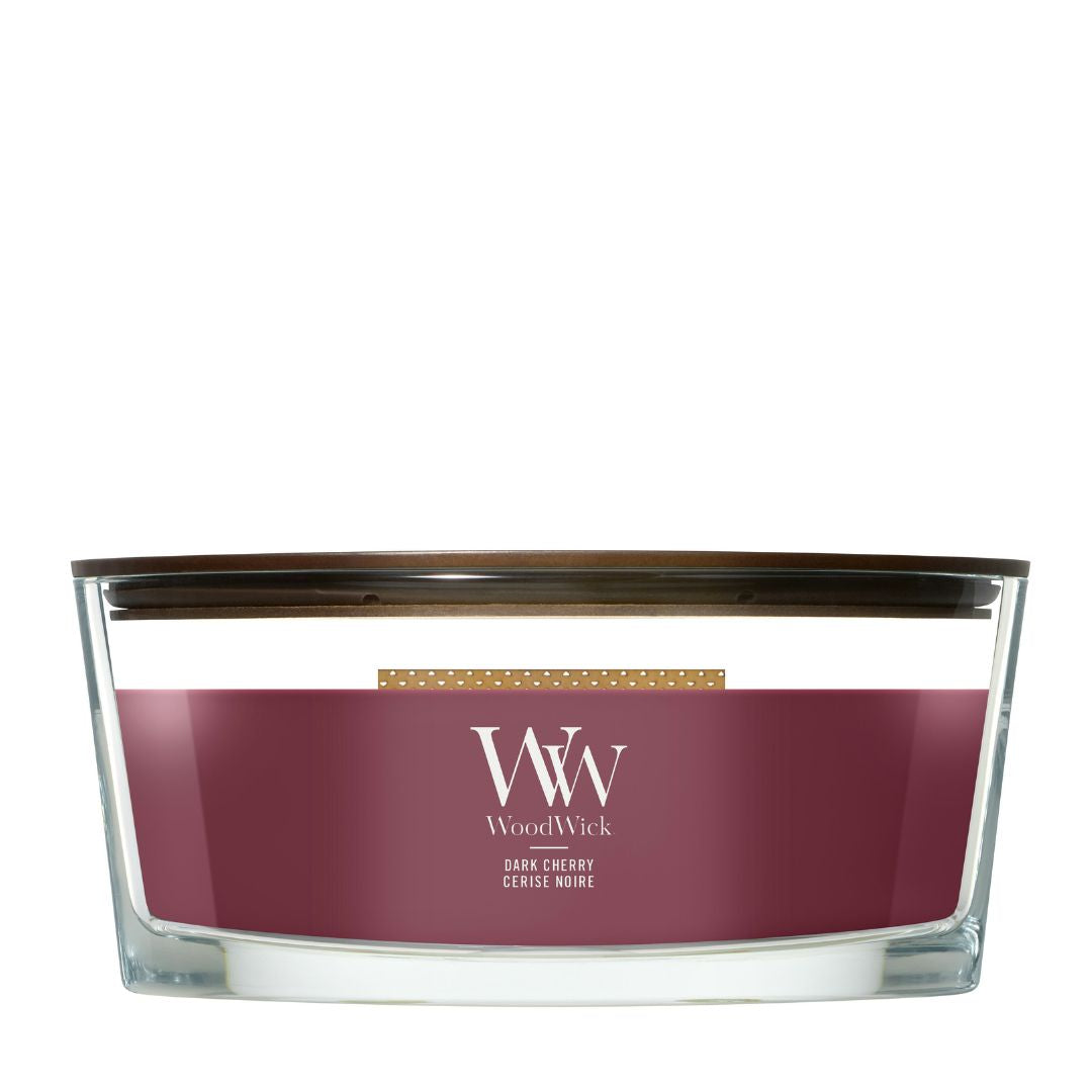 Candela WoodWick Dark Cherry Ellipse in vaso di vetro con coperchio in legno.
