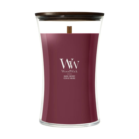 Candela WoodWick Dark Cherry grande in vaso di vetro con coperchio in legno.