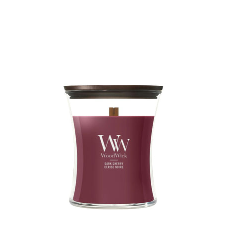 Candela WoodWick Dark Cherry media vaso di vetro con coperchio in legno.