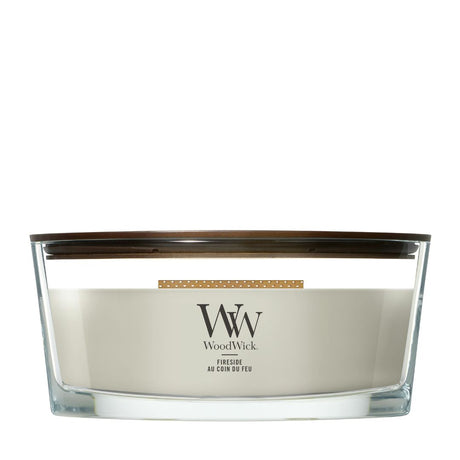 Candela WoodWick Fireside Ellipse in vaso di vetro con coperchio in legno.