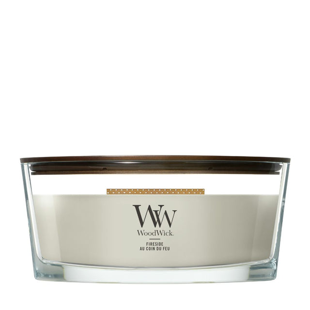 Candela WoodWick Fireside Ellipse in vaso di vetro con coperchio in legno.