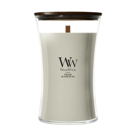 Candela WoodWick Fireside grande in vaso di vetro con coperchio in legno.