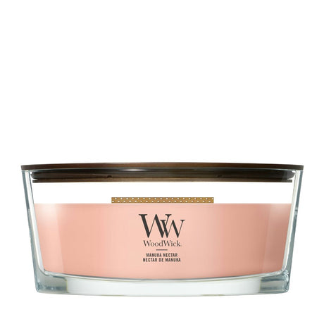 Candela WoodWick Manuka Nectar Ellipse in vaso di vetro con coperchio in legno.