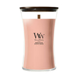 Candela WoodWick Manuka Nectar grande in vaso di vetro con coperchio in legno.