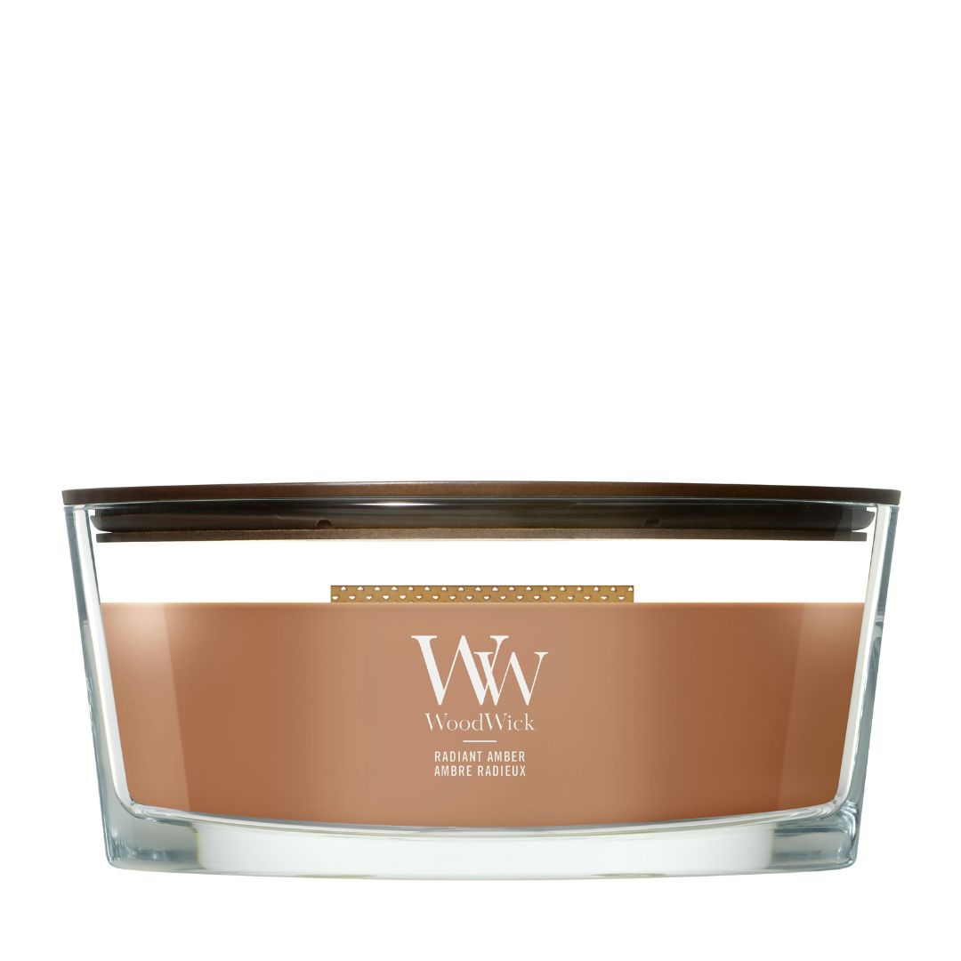 Candela WoodWick Radiant Amber Ellipse in vaso di vetro con coperchio in legno.