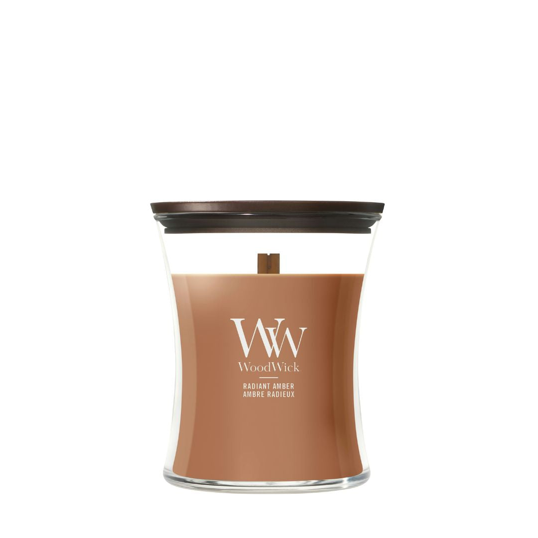 Candela WoodWick Radiant Amber media in vaso di vetro con coperchio in legno.