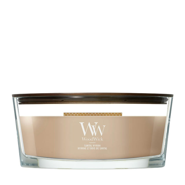 Candela WoodWick Santal Myrrh Ellipse in vaso di vetro con coperchio in legno.