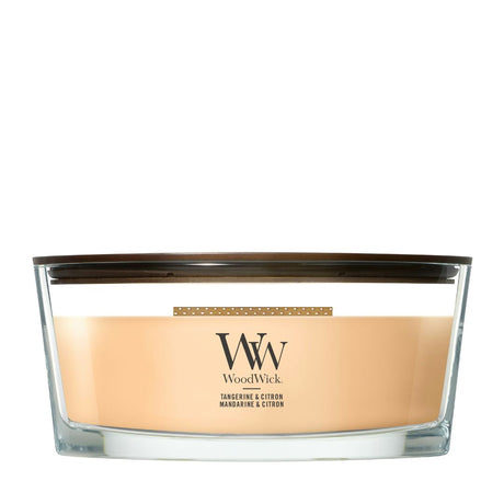Candela WoodWick Tangerine & Citron ellipse in vaso di vetro con coperchio in legno.