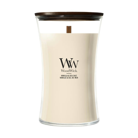 Candela WoodWick Vanilla & Sea Salt grande in vaso di vetro con coperchio in legno.