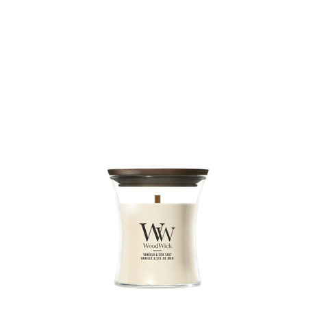 Candela WoodWick Vanilla & Sea Salt piccola in vaso di vetro con coperchio in legno.