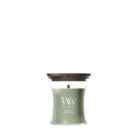 Candela WoodWick Verdant Fig piccola in vaso di vetro con coperchio in legno.