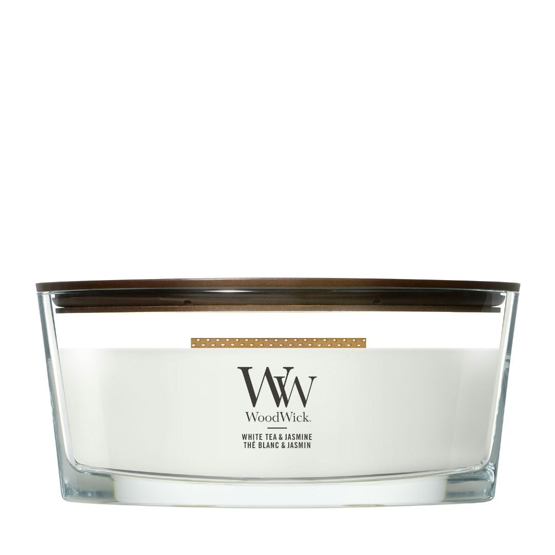 Candela WoodWick White Tea & Jasmine Ellipse in vaso di vetro con coperchio in legno.