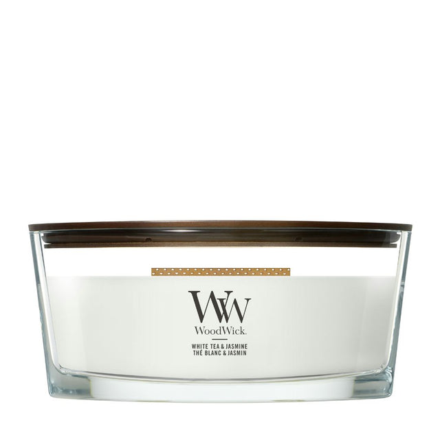 Candela WoodWick White Tea & Jasmine Ellipse in vaso di vetro con coperchio in legno.