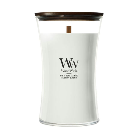 Candela WoodWick White Tea & Jasmine grande in vaso di vetro con coperchio in legno.