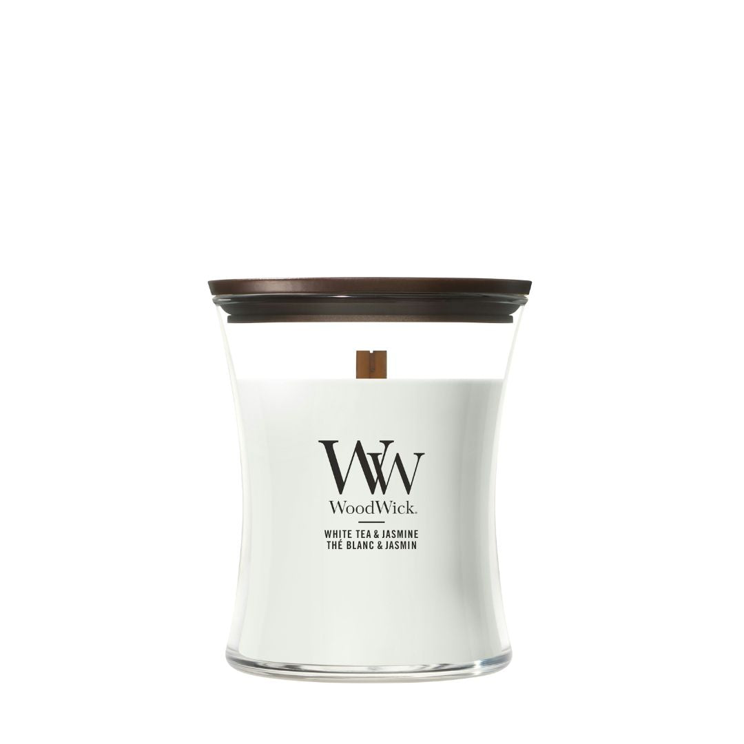 Candela WoodWick White Tea & Jasmine media in vaso di vetro con coperchio in legno.