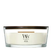 Candela WoodWick White Teak Ellipse in vaso di vetro con coperchio in legno.