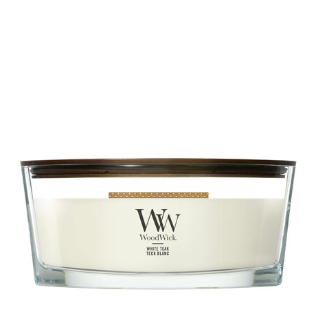 Candela WoodWick White Teak Ellipse in vaso di vetro con coperchio in legno.